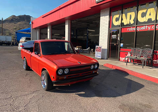 Orange Datsun pickup truck