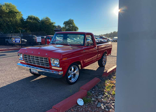 Restored red Ford F-100 pickup at golden hour
